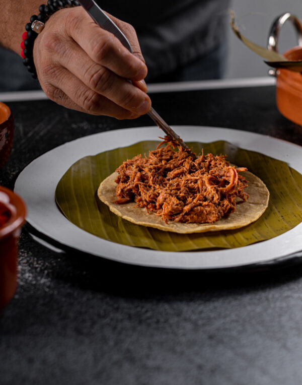 Serving cochinita pibil taco